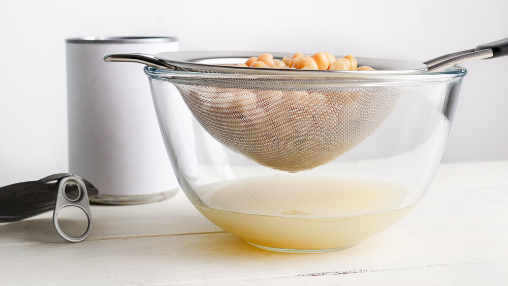 Draining chickpeas in strainer over bowl