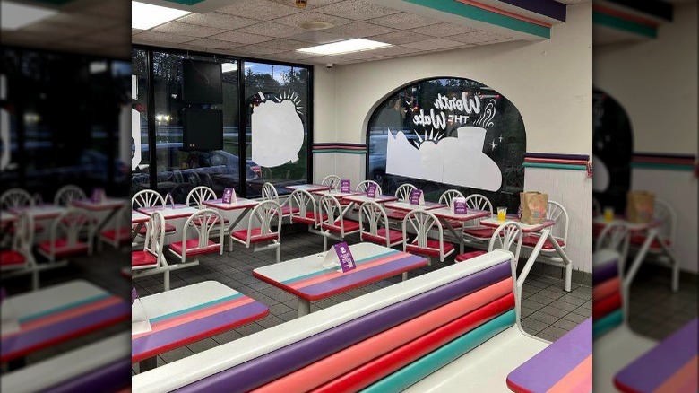 A Taco Bell with the 1990's "Miami Vice" interior design 