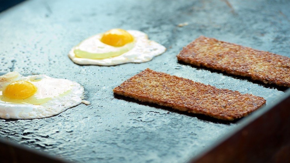 Griddled goetta slices and fried eggs