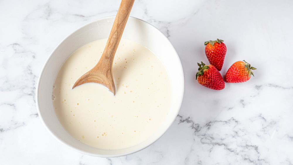 mixing milk topping for tres leches cake