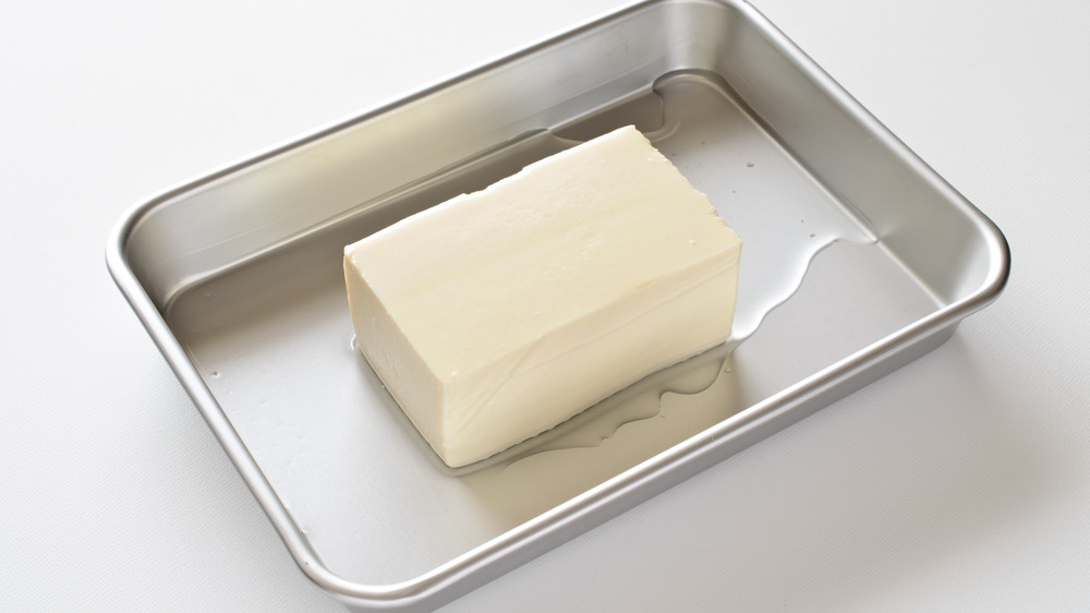 Silken tofu block on a white background