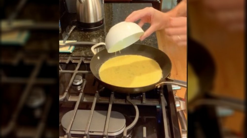 A picture of a guy cooking eggs