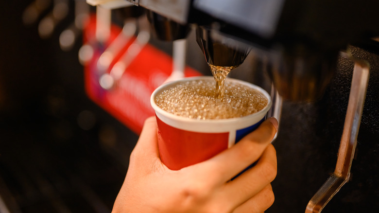 pouring soda from machine