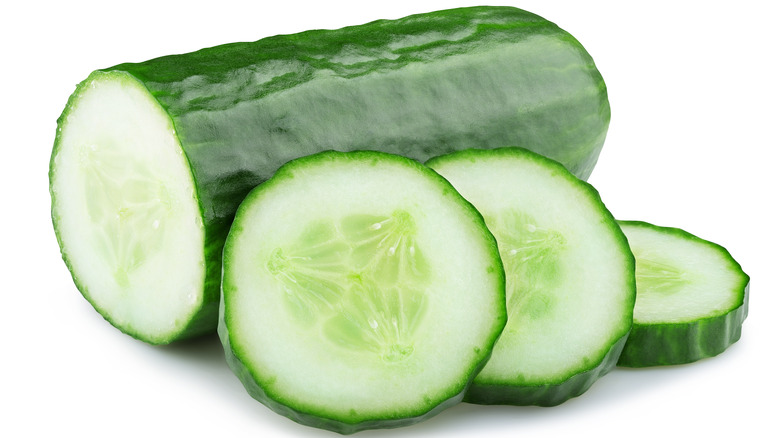 Sliced up cucumber on a white background