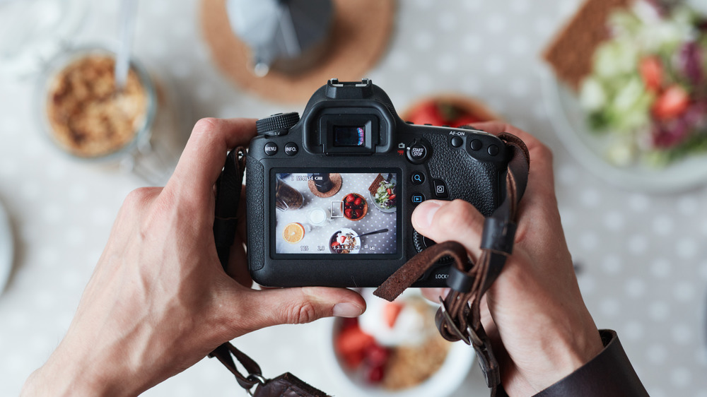 Person taking a picture of food with camera