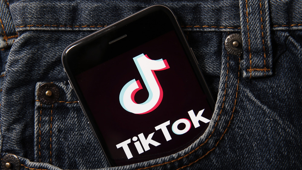 A phone with TikTok's logo sticking out of the pocket. TikTok is the present and the future until it isn't.