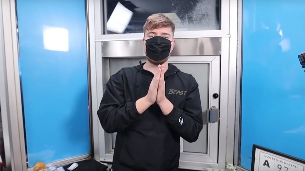 masked MrBeast folded palms