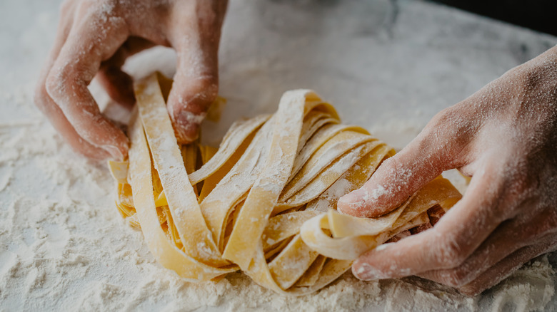 hands making fresh pasta