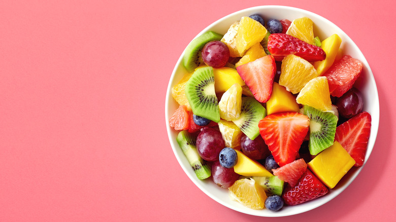 Fruit salad on pink background