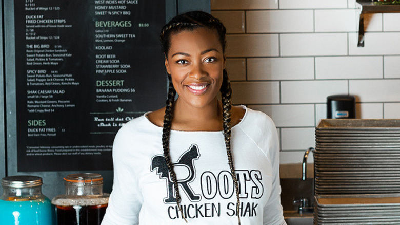 Tiffany Derry standing in front of the menu