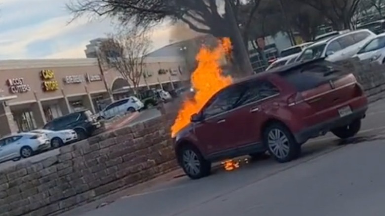 Red Lincoln car on fire