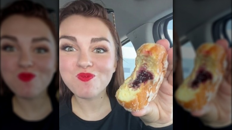 TikToker @karissaeats eating a jelly donut from Dunkin.