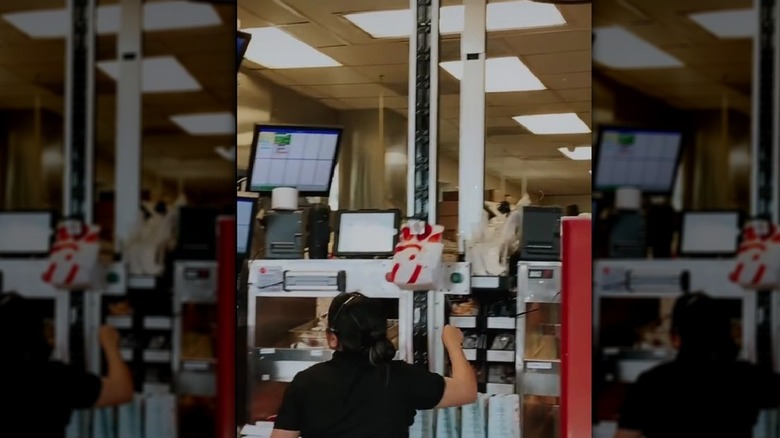 Worker attaches a bag to a claw