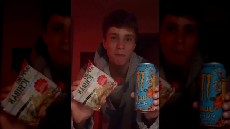 Sean holding ramen and monster