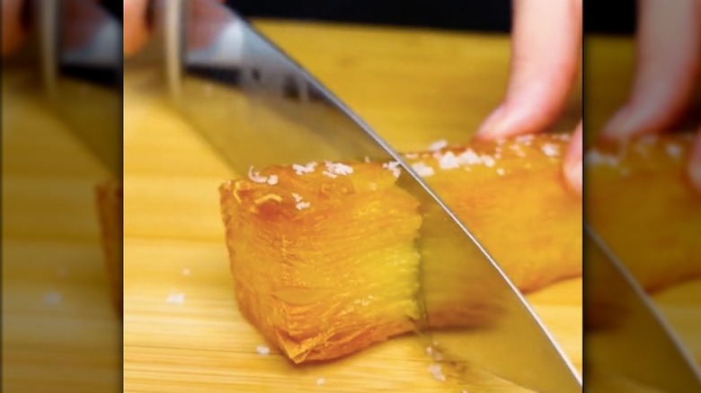 Slicing a crispy potato bar