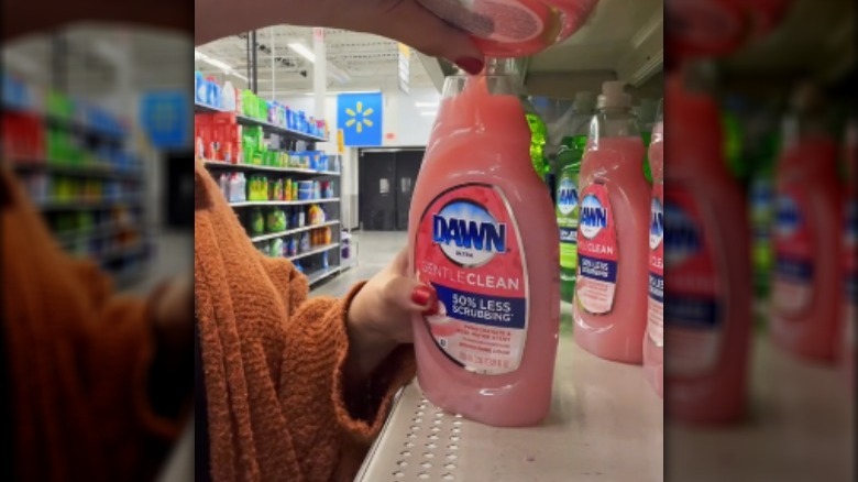 Person pouring dish soap into bottle