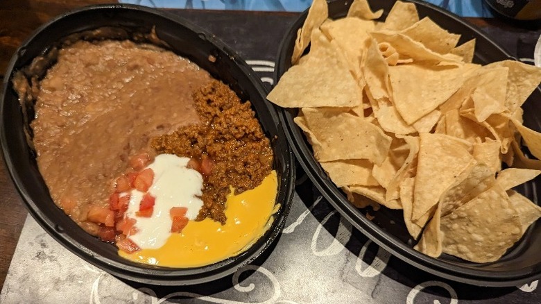 Taco Bell Nachos BellGrande with chips on the side.