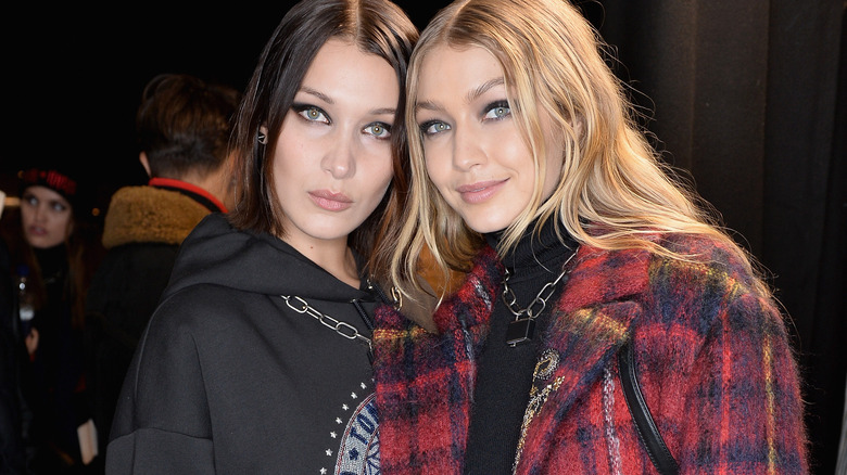 Bella and Gigi Hadid backstage before a Tommy Hilfiger fashion show