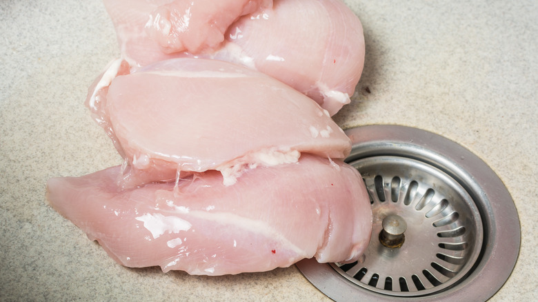 Raw chicken in a sink