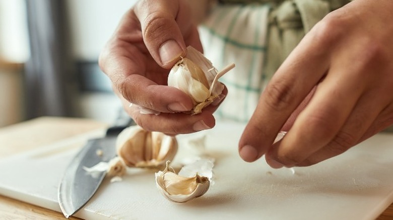 Hands holding garlic cloves