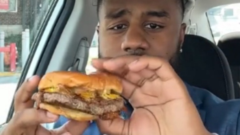 Chick-fil-A cheeseburger held by Ryan Mabry