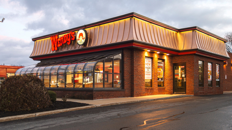 The exterior of a Wendy's location is seen on a cloudy day