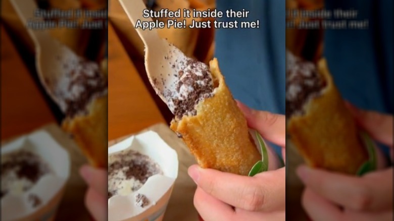 A person stuffing an Oreo McFlurry into a McDonald's Apple Pie