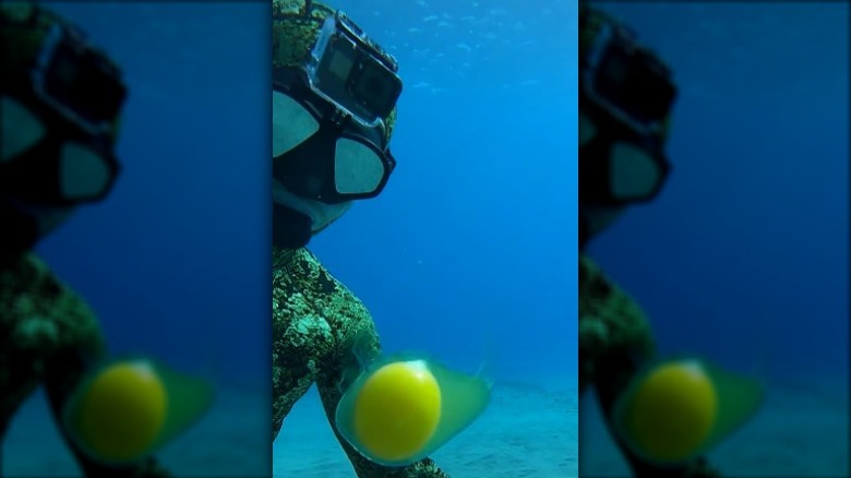 Diver in ocean with floating egg yolk