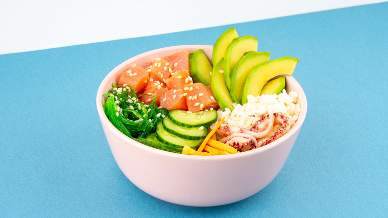 Rice bowl with salmon, avocado, and cucumber