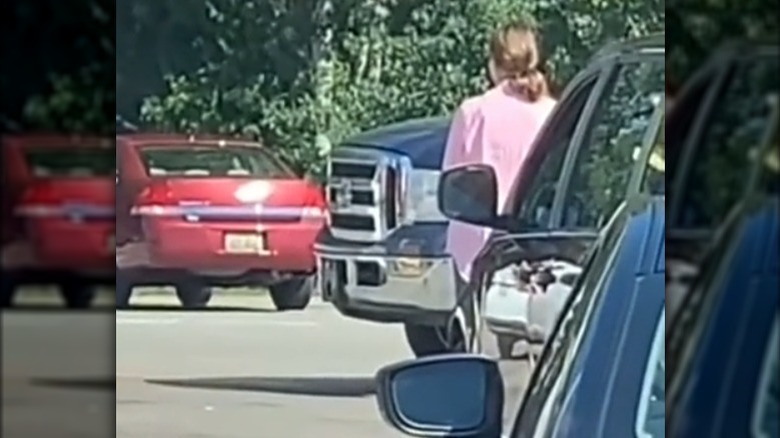 Woman holding up traffic at drive-thru