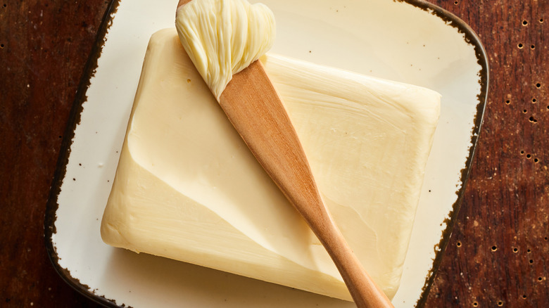 Slab of butter with a wooden knife