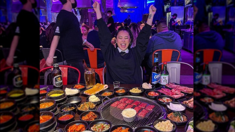 Ashley Yi cheering at a table