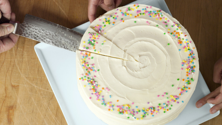 Knife lifting slice of cake