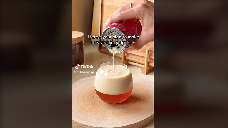 hand pouring milk from can