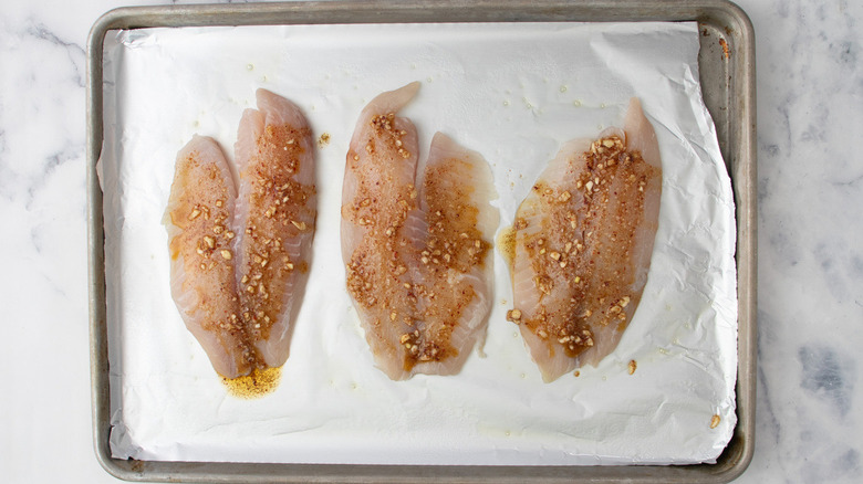 seasoned tilapia filets in pan