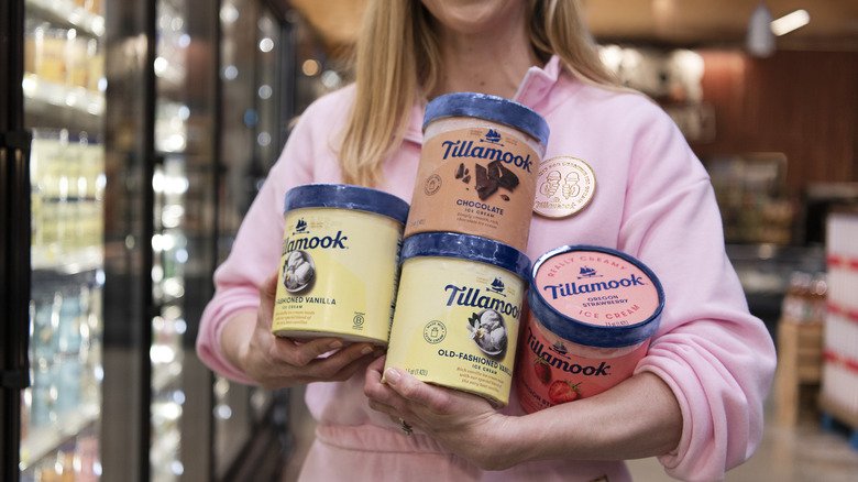 Woman holding four containers of Tillamook ice cream