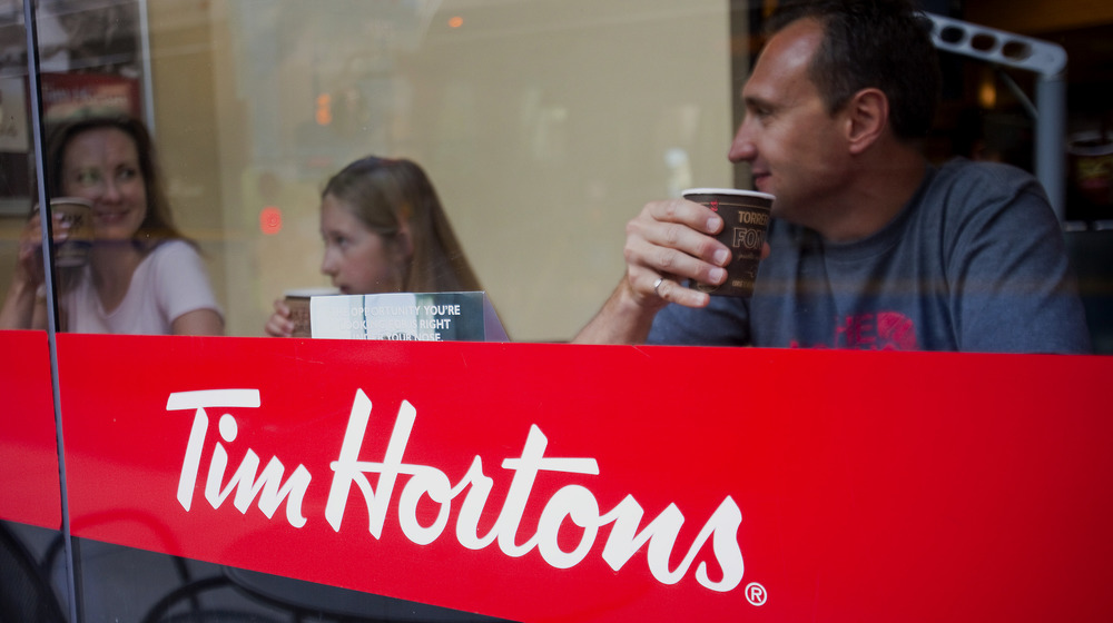 Customers sip coffee at a Tim Hortons restaurant