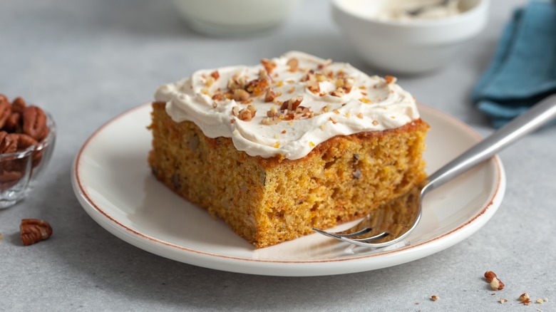 Carrot cake on white plate with fork