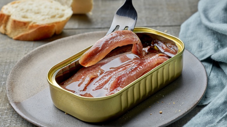 tinned anchovies open with fork