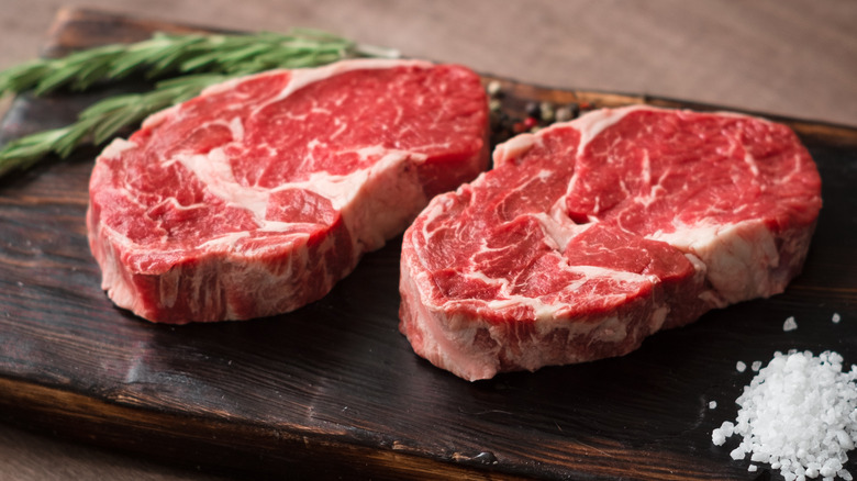 Raw steak on cutting board