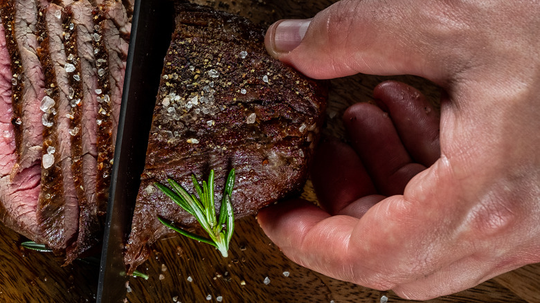 Chef cutting through steak