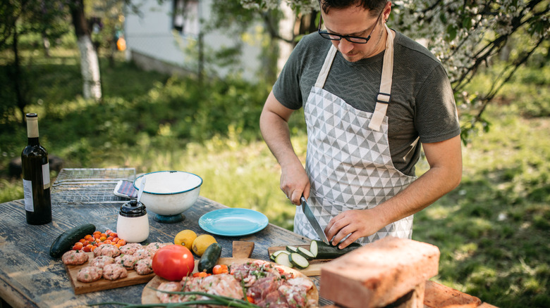 man cutting food cutting boards