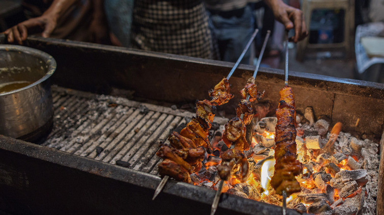 cooking meat over fire