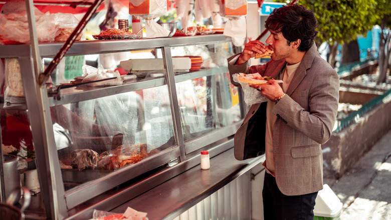 man eating street food