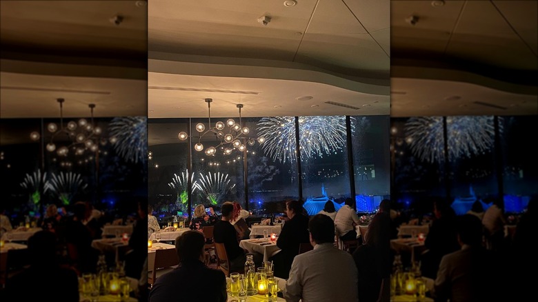 restaurant tables facing Disney fireworks