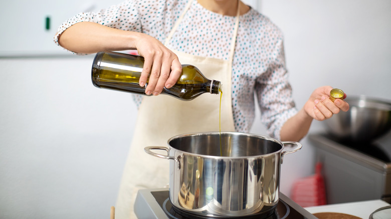 pouring oil into stove pot