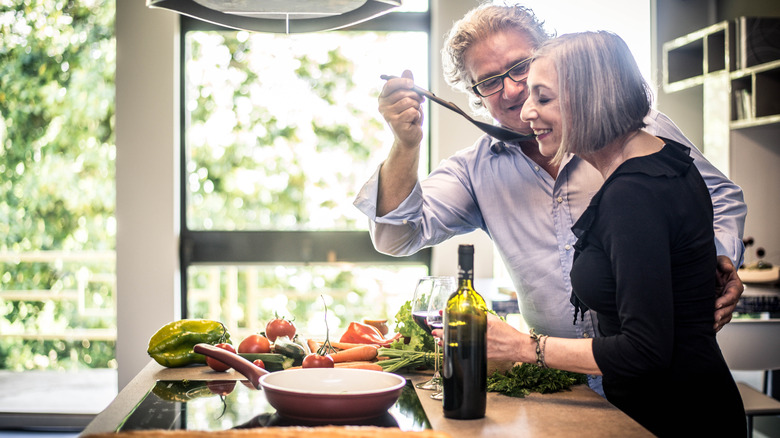 man and woman tasting food