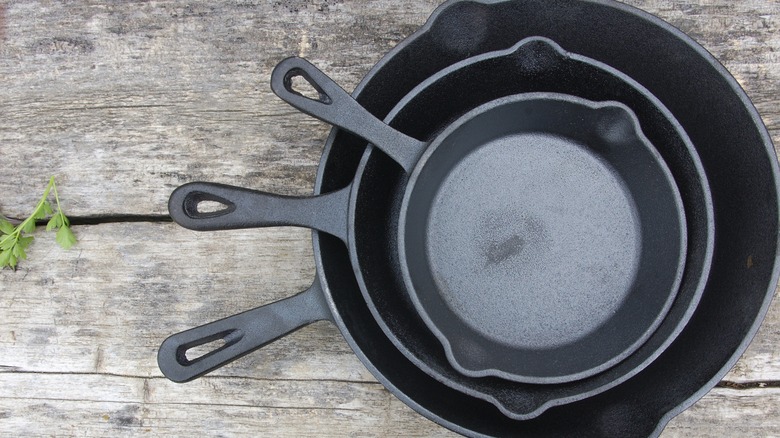 three cast iron skillets stacked