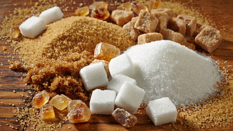 white and brown sugar in piles