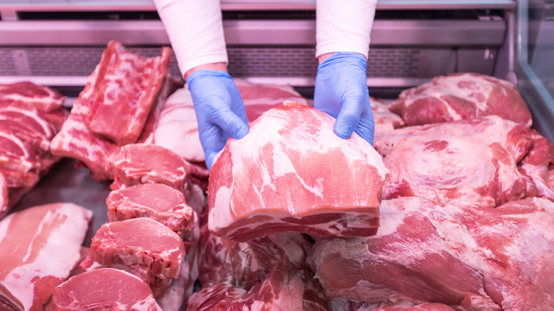 Butcher holding piece of meat